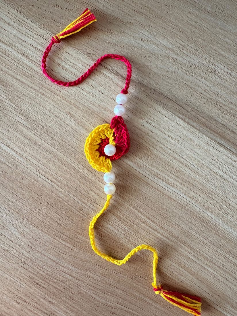 Floral Pearl Lumba — handmade crochet rakhi by TASSELA