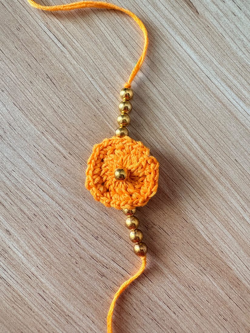 Handmade marigold crochet rakhi by TASSELA