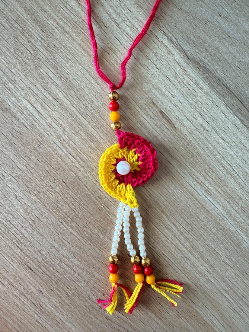 Marigold Lumba Rakhi — handmade crochet rakhi by TASSELA